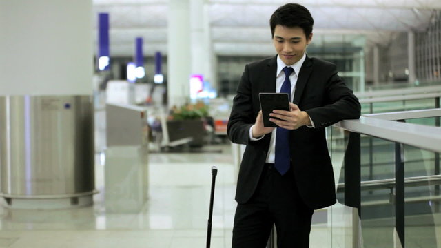 Young Asian Chinese Finance Travel Meeting Airport Mini Tablet Technology