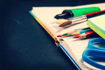 School supplies on black background, vintage color tone