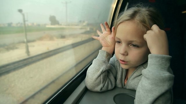 girl looking out the window on the train