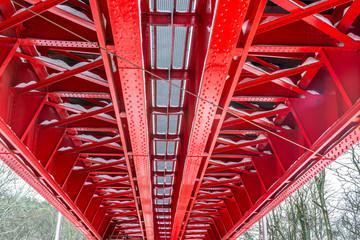 Historic red railroad bridge, bottom view