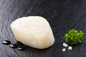 Scallop on black stone plate