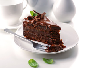 Delicious chocolate cake on plate on table on light background