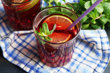 Pomegranate drink in glasses with mint and slices of lime