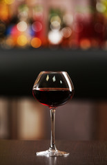 Glass of red wine in bar on blurred background