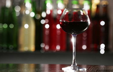 Glass of red wine in bar on blurred background