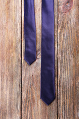 Trendy tie on wooden planks background