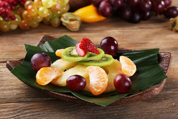 Fruit dessert on green leaf on table