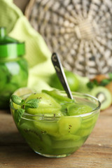 Tasty kiwi jam in glass bowl and jar