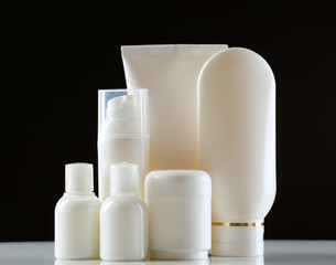 Group of cosmetic bottles on dark background