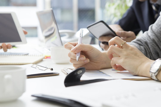 The hands of the women who are taking notes