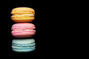 Colorful macaroon over black background