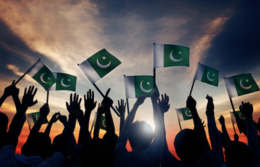 Group of People Waving Flag of Pakistan in Back Lit - obrazy, fototapety, plakaty