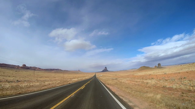 POV driving sandstone Buttes desert landscape blue Monument Valley Arizona USA