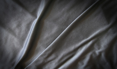 Obraz premium Black creased material background or texture