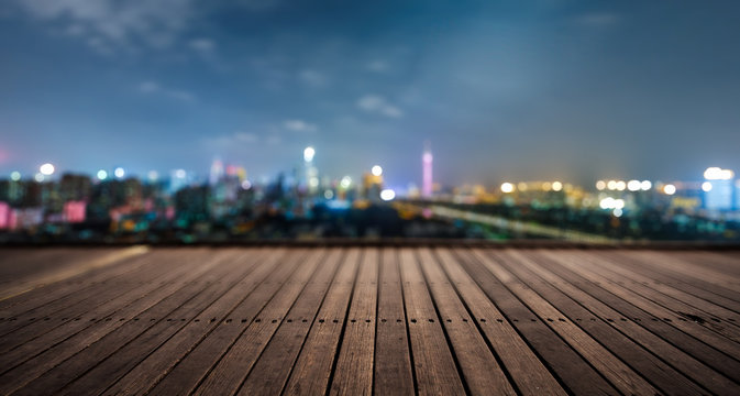 wooden platform and lights of night city