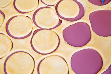 circles of dough on the purple board
