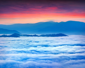 Sunrise over the sea of fog in the mountains at the summer