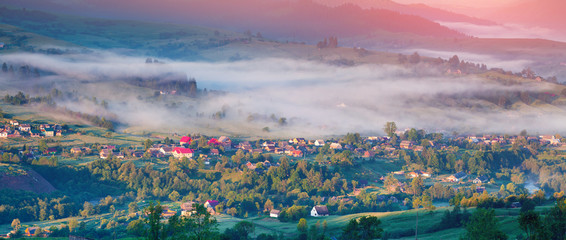 Colorful summer panorama of the sunrise un mountain village