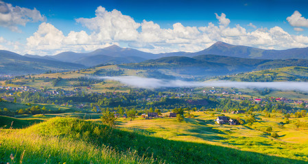 Fototapeta premium Panorama of the colorful summer morning in mountain village.