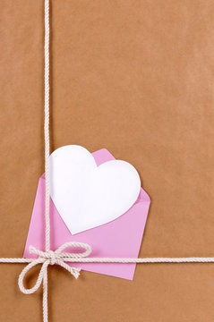Brown paper package parcel background with valentine heart shape card gift tag or love message photo