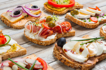 Sandwiches on wooden background, closeup - 76962429