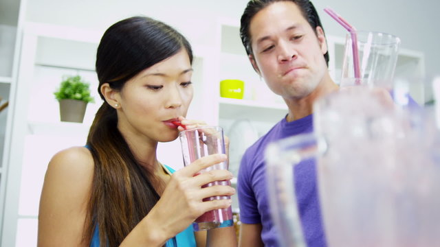 Health Conscious Asian Chinese Couple Drinking Organic Fruit Drink