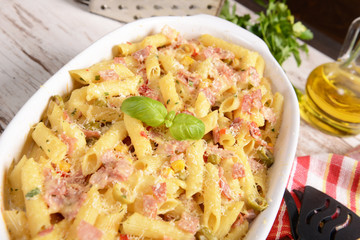 Penne pasta casserole with cheese, ham and corn