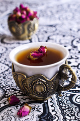 Tea roses in a beautiful Cup with Oriental motifs