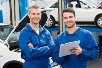 Team of mechanics smiling at camera