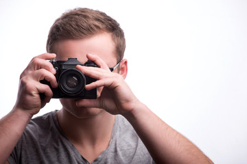 Young handsome man with photo camera