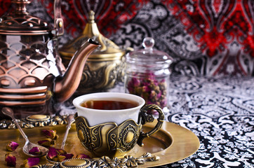 Tea roses in a beautiful Cup with Oriental motifs