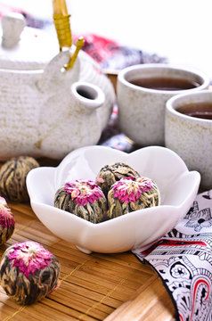 Green tea in the form of a ball with a red flower