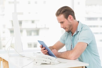 Casual businessman using tablet