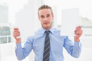 Cheerful businessman showing documents