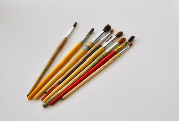 different brushes on a white canvas