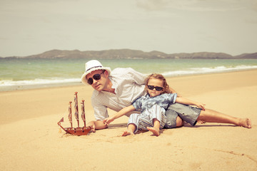 Father and son playing on the beach at the day time.