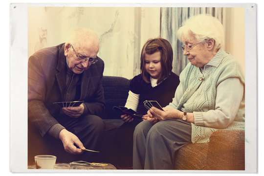 Grandparents playing cards with grandchild