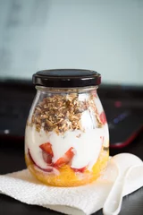 Tuinposter Granola with Fruits and Yogurt Ready to Take to Work as a Snack © inats