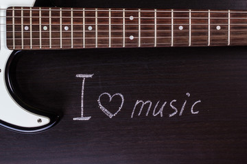 text "I love music" against the backdrop of guitar
