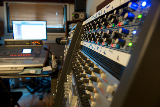 several mixing consoles in a recording studio