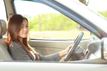 beautiful happy woman driving a car