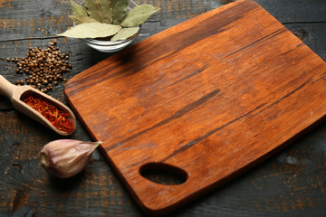 Different spices and herbs with cutting board