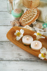 Composition of spa treatment, candles in bowl with water