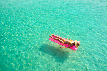 Woman relaxing on inflatable mattress