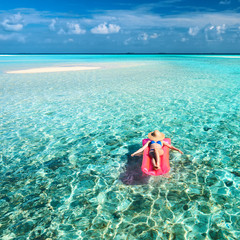 Woman relaxing on inflatable mattress