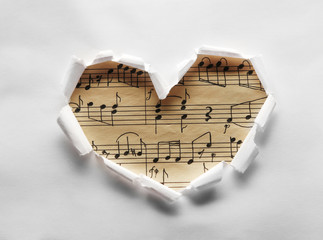Torn paper heart over colorful background