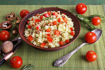 Rice with walnuts and cherry tomatoes in plate