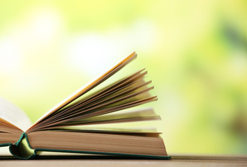 Open book on blurred bright background