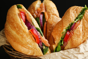 Sandwiches with salmon, close-up, on dark background