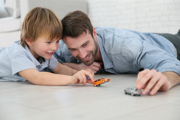 Daddy with little boy playing with toy cars © goodluz